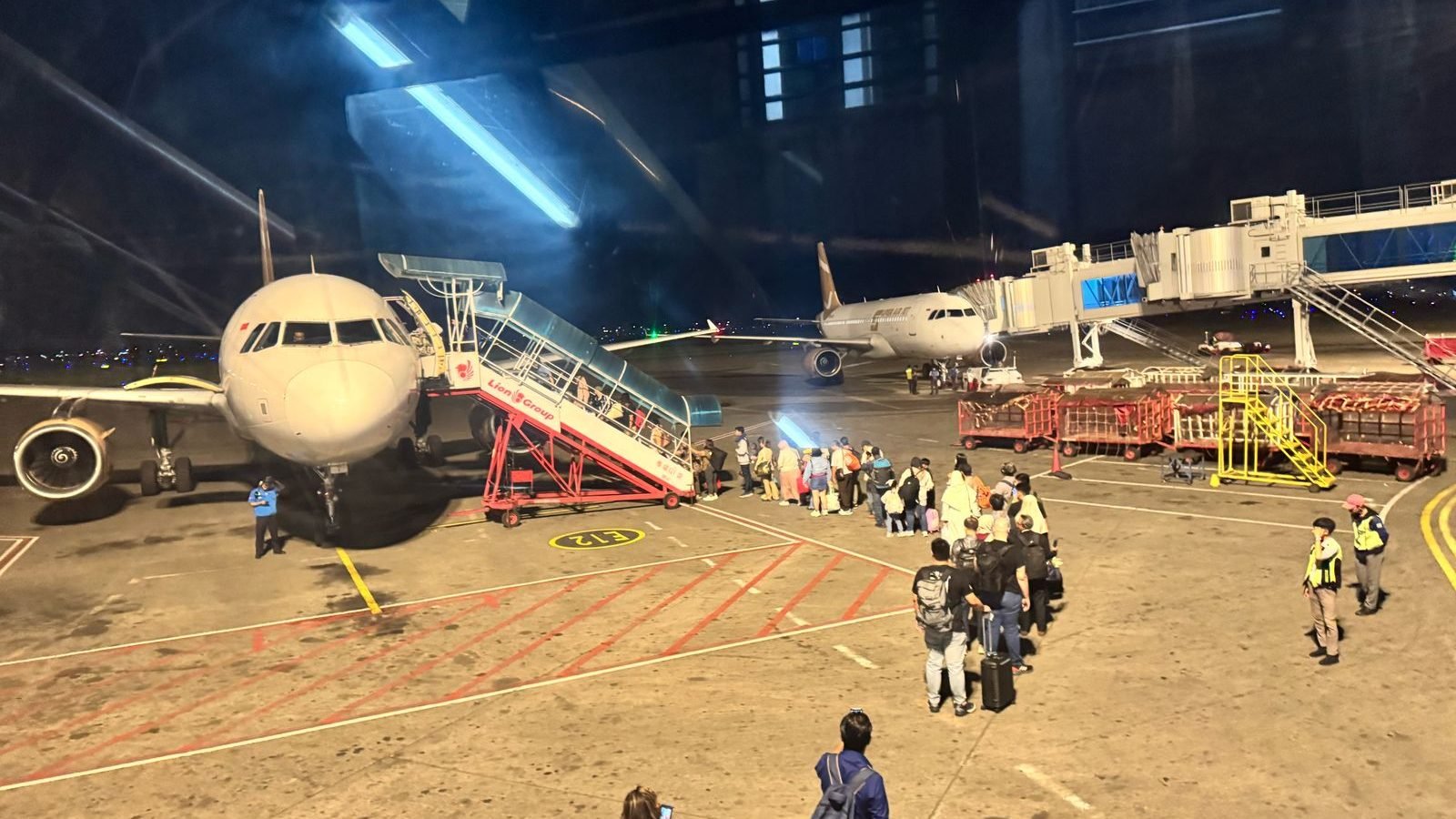 Penumpang Super Air Jet mengantre untuk naik ke pesawat pengganti dengan registrasi SGA menggunakan tangga manual di apron Bandara Soekarno-Hatta, Selasa malam (20/5/2025), beberapa penumpang memilih untuk tidak melanjutkan penerbangan. (Dok. Tim/Faktakalbar.id)