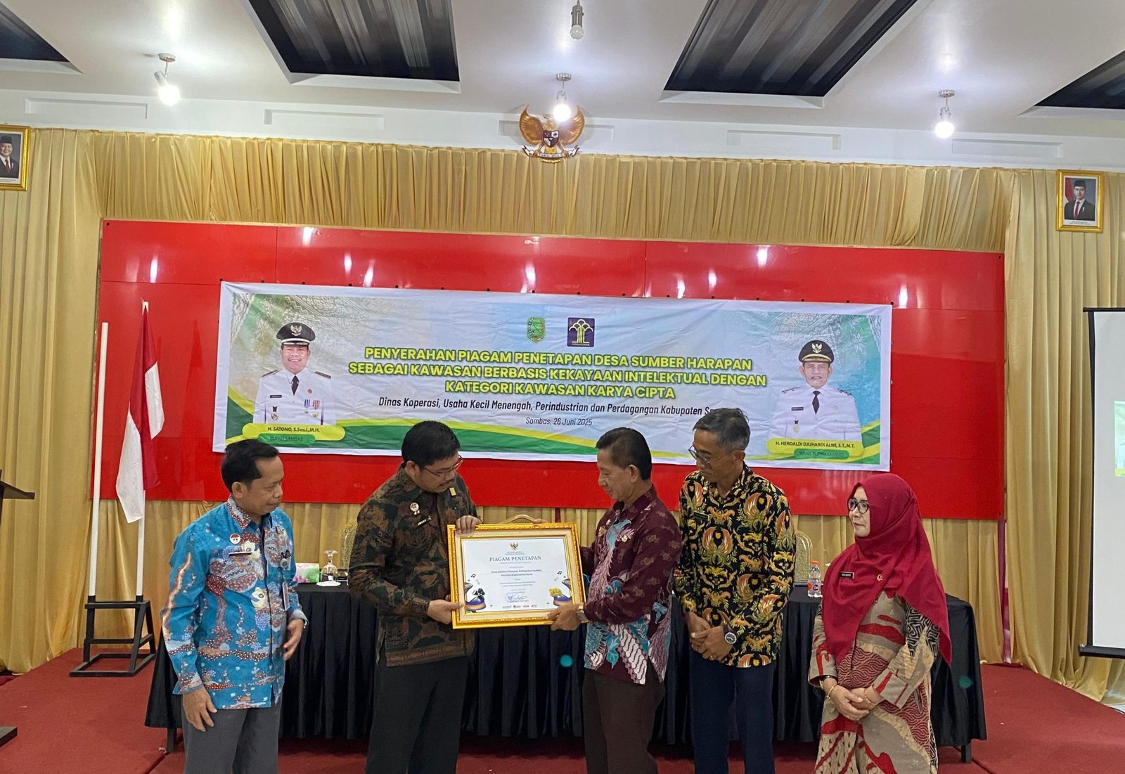 Pemkab Sambas menerima piagam Penetapan Desa Sumber Harapan Sebagai Kawasan Berbasis Kekayaan Intelektual Kategori Kawasan Karya Cipta oleh Kepala Kantor Wilayah Kementerian Hukum dan HAM Kalimantan Barat saat ini dijabat oleh Jonny Pesta Simamora ,Kamis (26/6/2025). (dok.faktakalbar)