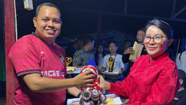 Bupati Landak, Karolin Margret Natasa, saat menutup Open Turnamen Sepak Bola Pahauman Banteng Cup 2025 dan menyerahkan piala kepada tim juara di Lapangan Setia Kawan, Desa Pahauman.