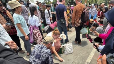 Para wisatawan asal Jerman tengah mencoba mendirikan telur di kawasan Tugu Khatulistiwa saat Kulminasi Matahari.