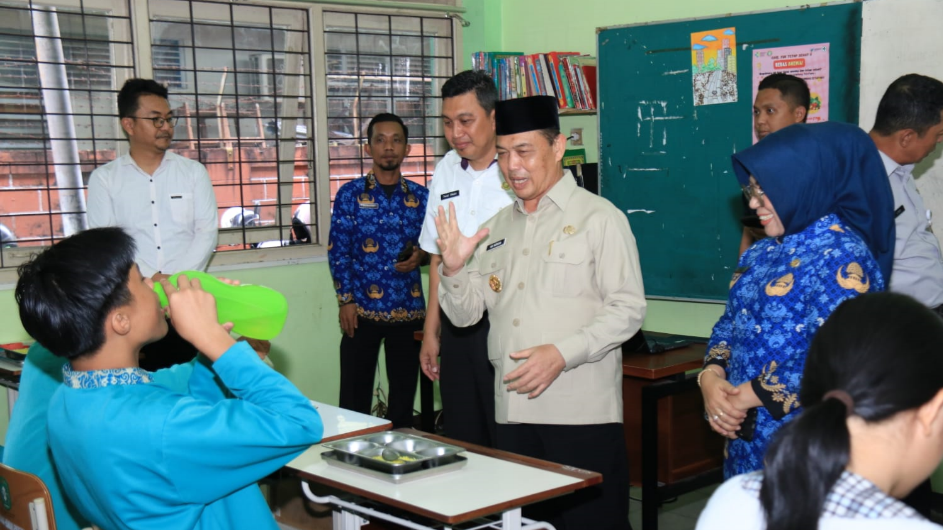 Gubernur Kalimantan Barat, Ria Norsan, sedang menyantap hidangan dari program Makan Bergizi Gratis (MBG) bersama para siswa di SMKN 5 Pontianak. (Dok. HO/Faktakalbar.id)