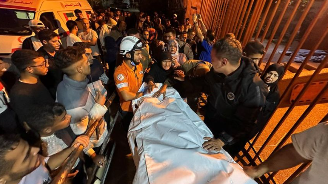 Petugas penyelamat dan warga mengevakuasi jenazah korban serangan udara Israel di Gaza, di tengah kerumunan yang berduka. (Dok. ISt)