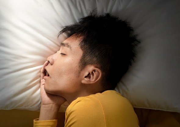 Ilustrasi seorang pria sedang tidur nyenyak bantal yang bersih dan nyaman, Mengganti bantal secara berkala adalah kunci untuk menjaga kebersihan dan kualitas tidur, serta mencegah risiko masalah kesehatan. (Dok. Ist)