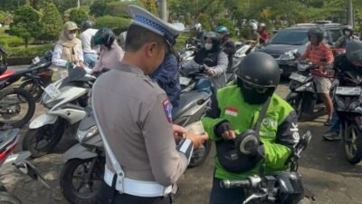 Personel Ditlantas Polda Kalbar saat melakukan pemeriksaan kelengkapan surat-surat kendaraan kepada pengendara yang melintas di Jalan Ahmad Yani, Pontianak, dalam rangka Operasi Zebra Kapuas 2025, Rabu (26/11/2025).