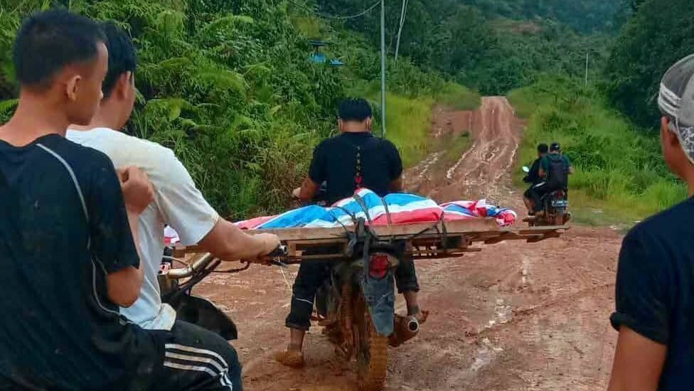 Warga terpaksa membawa jenazah melintasi jalan rusak dengan motor. (Foto: Istimewa)