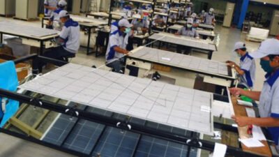 Para pekerja menyelesaikan produksi panel surya atau modul surya di pabrik produksi PT LEN Industri. (Dok. industrial-tourism)