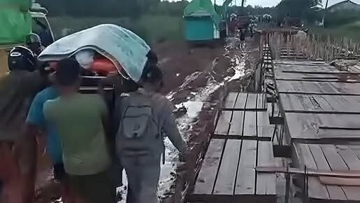 Sejumlah warga terpaksa menggotong keranda jenazah melewati jalan berlumpur akibat kemacetan parah di lokasi perbaikan Jalan Pelang, Kabupaten Ketapang.