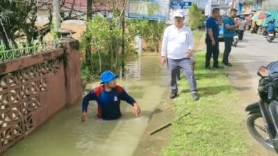 Bupati Sanggau, Yohanes Ontot, saat meninjau langsung proses pembersihan dan pembongkaran penutup saluran air di kawasan Taman Arongk Balopa, Selasa (23/12).