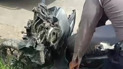 Petugas kepolisian memeriksa kondisi sepeda motor yang hancur usai terlibat kecelakaan dengan truk trailer di depan Pelabuhan Dwikora Pontianak, Jumat (19/12/2025).