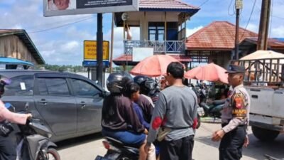 Personel Polres Sekadau saat melakukan pengaturan lalu lintas untuk mengurai kemacetan di kawasan Pasar Sekadau, Jalan Kapuas, Selasa (23/12/2025).