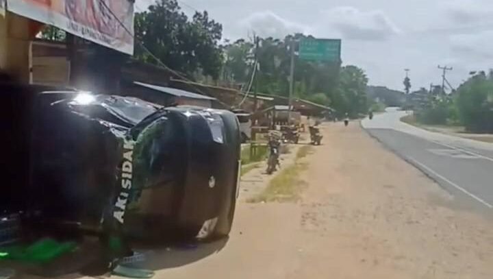 Kondisi mobil pick up Grandmax yang terguling dan menimpa teras toko serta sepeda motor warga di Batang Tarang, Kabupaten Sanggau, Kamis (22/1).