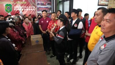 Wali Kota Singkawang Tjhai Chui Mie membagikan paket sembako secara simbolis kepada warga dalam kegiatan bakti sosial di Kantor Sekretariat Hakka Singkawang. (Dok. HO/Faktakalbar.id)