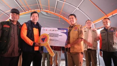 Kepala BNPB Suharyanto menyerahkan kunci secara simbolis kepada salah satu perwakilan warga penerima manfaat huntara di Kecamatan Ketol, Aceh Tengah, Sabtu (15/2/2026).