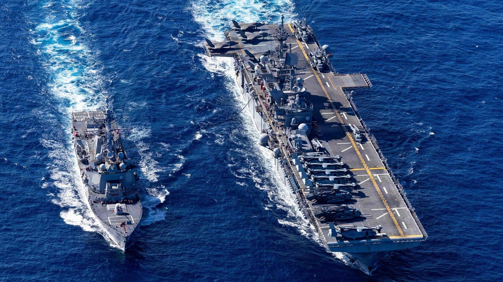Kapal induk amfibi USS Tripoli berlayar berdampingan dengan kapal perusak di laut lepas membawa jet tempur F-35B. (Dok. ISt)