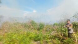 Aparat kepolisian memadamkan titik api di dekat kawasan permukiman. (Dok. Ist)